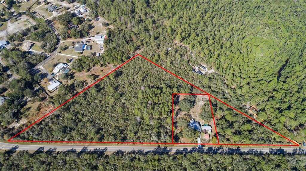 An aerial view shows a large, wooded lot with a house outlined in red — REYNOLDS, LOT 0420 ROAD Lot 0420, DE LEON SPRINGS, FL