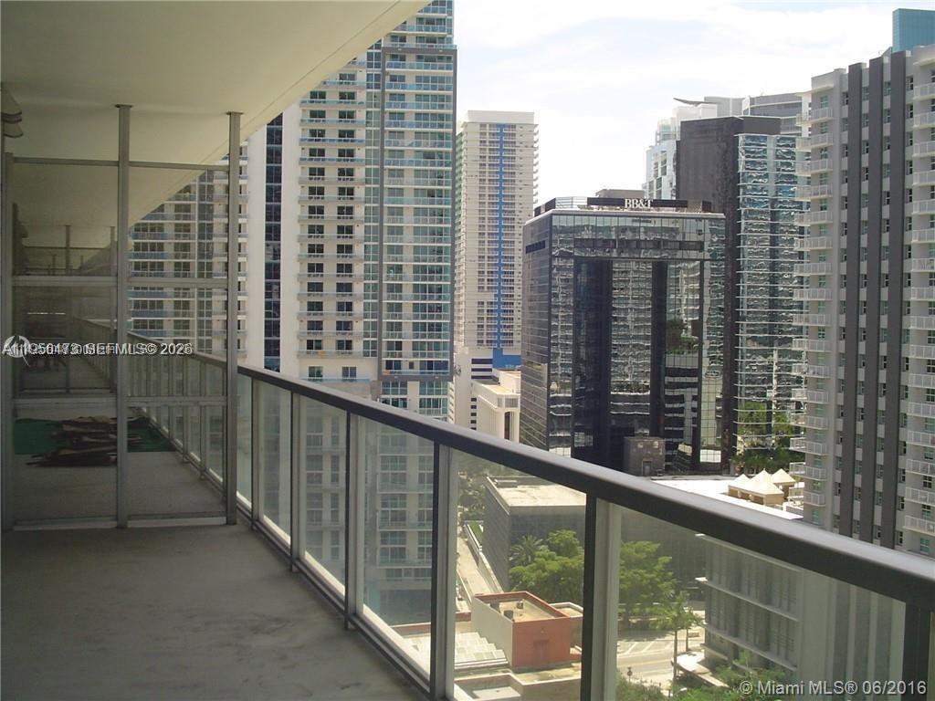 A high-rise balcony overlooks a dense urban cityscape with multiple glass skyscrapers — 1111 SW 1st Ave, Miami FL 33130, MIAMI, FL