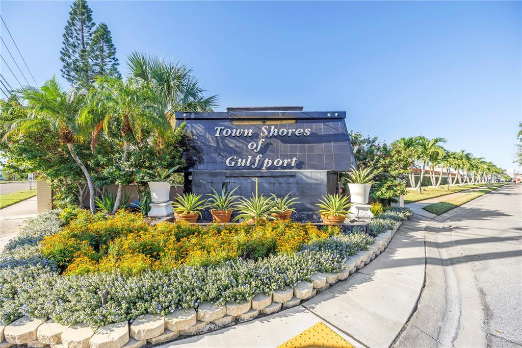A stone sign for Town Shores of Gulfport sits behind a landscaped garden bed — 6020 SHORE BOULEVARD S UNIT 712, GULFPORT, FL