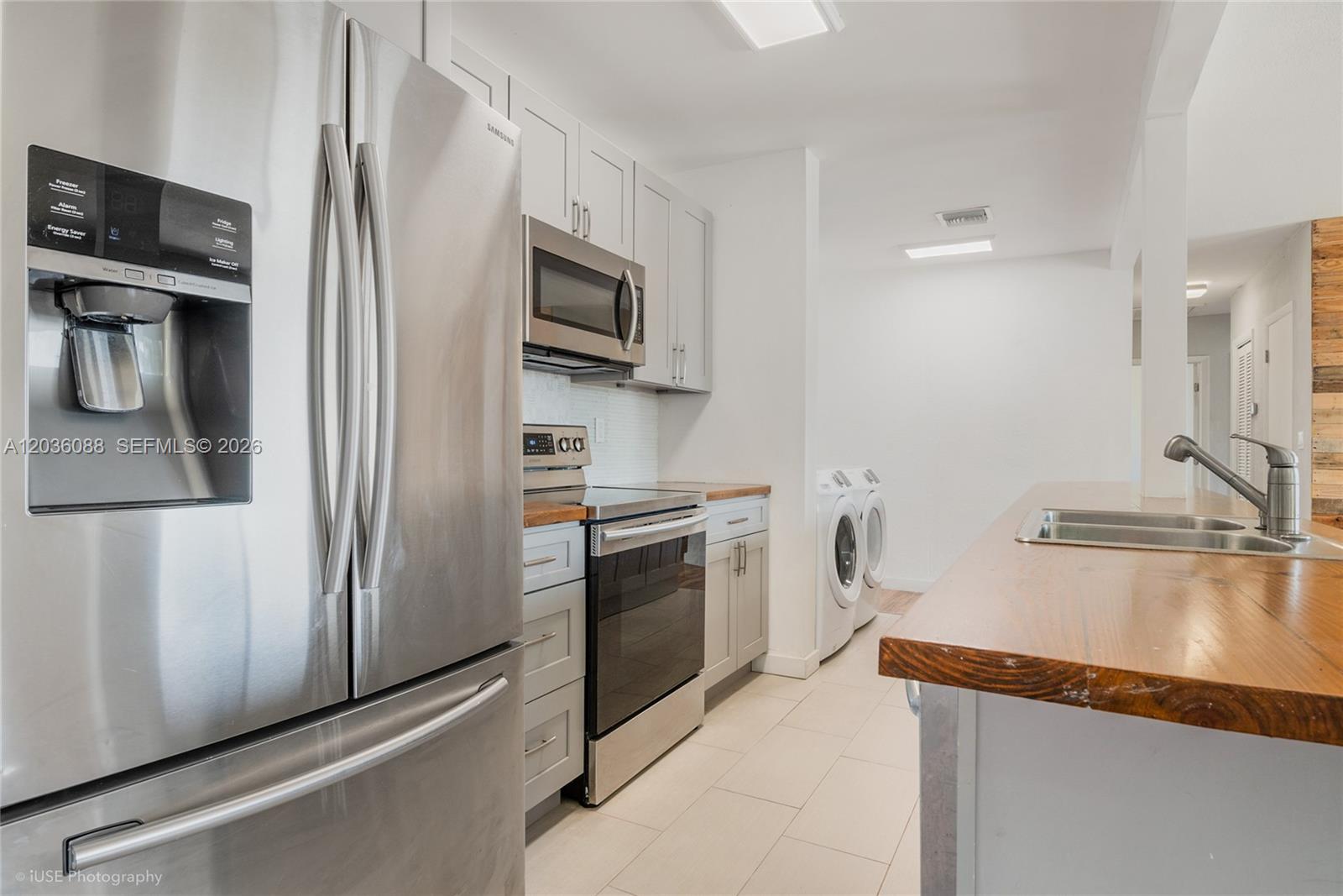 A kitchen features stainless steel appliances, light gray cabinets, and a wood countertop island — 11601 SW 141st St, Miami FL 33176, MIAMI, FL