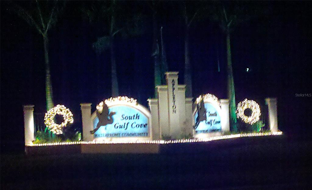 The illuminated entrance sign for the South Gulf Cove waterfront community is shown at night — 15009 APPLETON BOULEVARD, PORT CHARLOTTE, FL