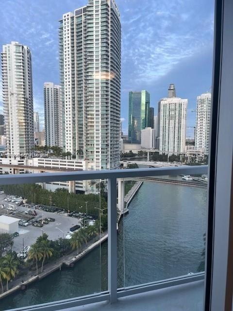 A view from a balcony overlooking a river, a parking lot, and several high-rise buildings — 185 SW 7th St # 1605, Miami FL 33130, MIAMI, FL