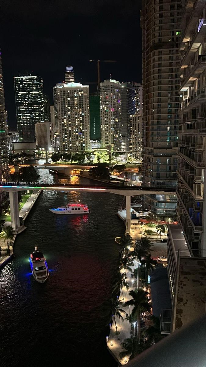 An elevated night view of a city river with boats, bridges, and illuminated skyscrapers — 185 SW 7th St # 1605, Miami FL 33130, MIAMI, FL