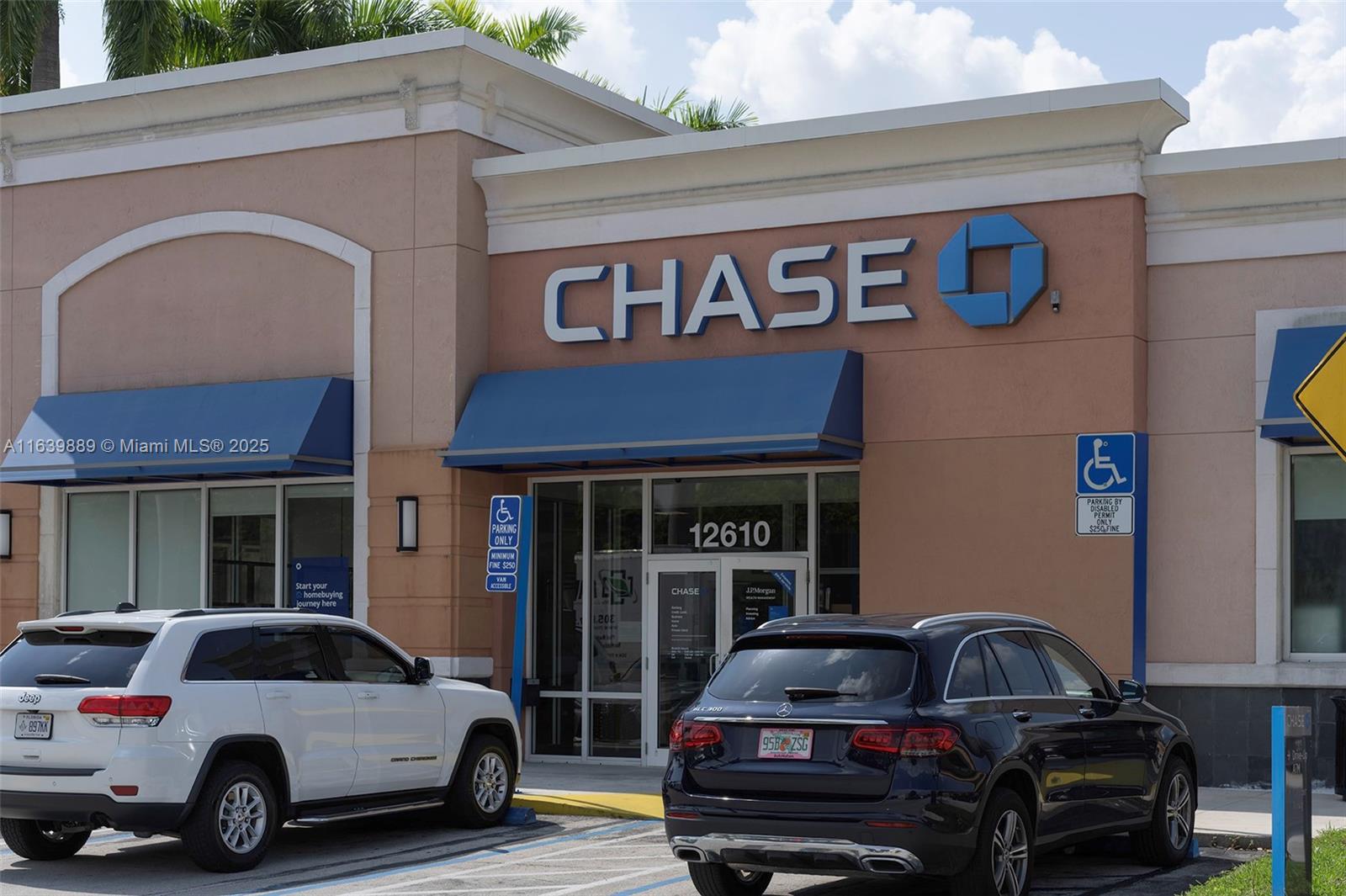 The exterior of a Chase bank branch features a tan facade and blue awnings — 12610 SW 120th St, Miami FL 33186, MIAMI, FL