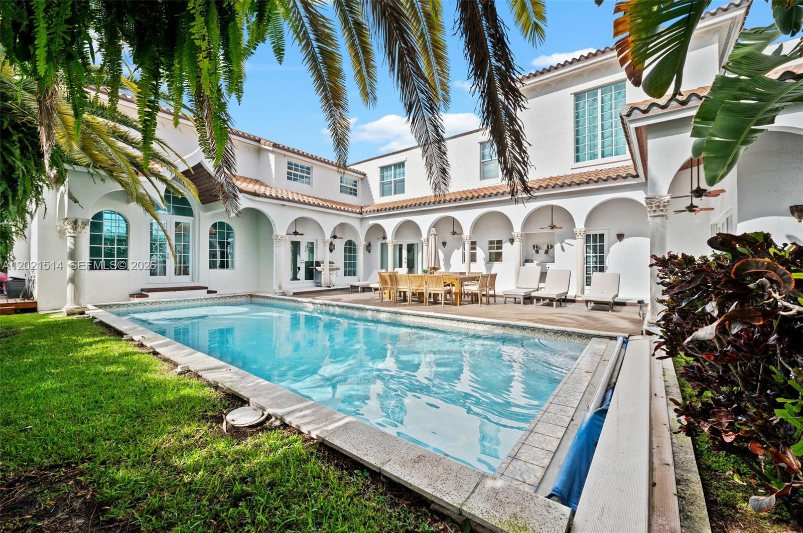 A two-story white stucco house with a swimming pool and a covered patio area — 2501 Pine Tree Dr, Miami Beach FL 33140, MIAMI BEACH, FL