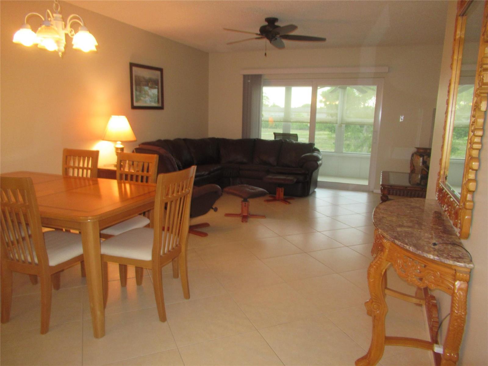 A hallway with tiled floors leads to a living area featuring mirrored closet doors — 601 NW 76th Terrace # 206, Margate FL 33063, MARGATE, FL