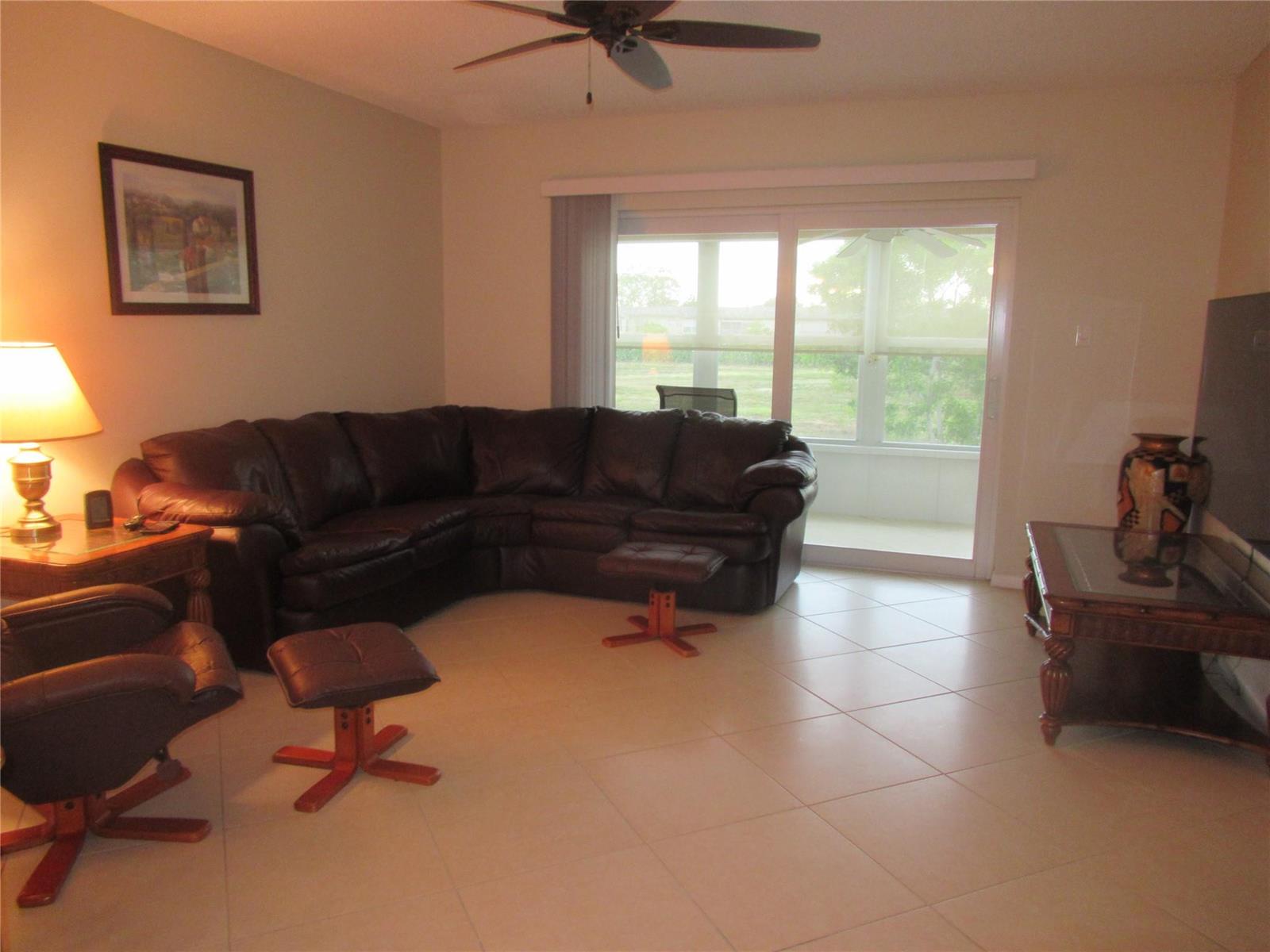 A kitchen features oak cabinets, granite countertops, a white dishwasher, and a white refrigerator — 601 NW 76th Terrace # 206, Margate FL 33063, MARGATE, FL