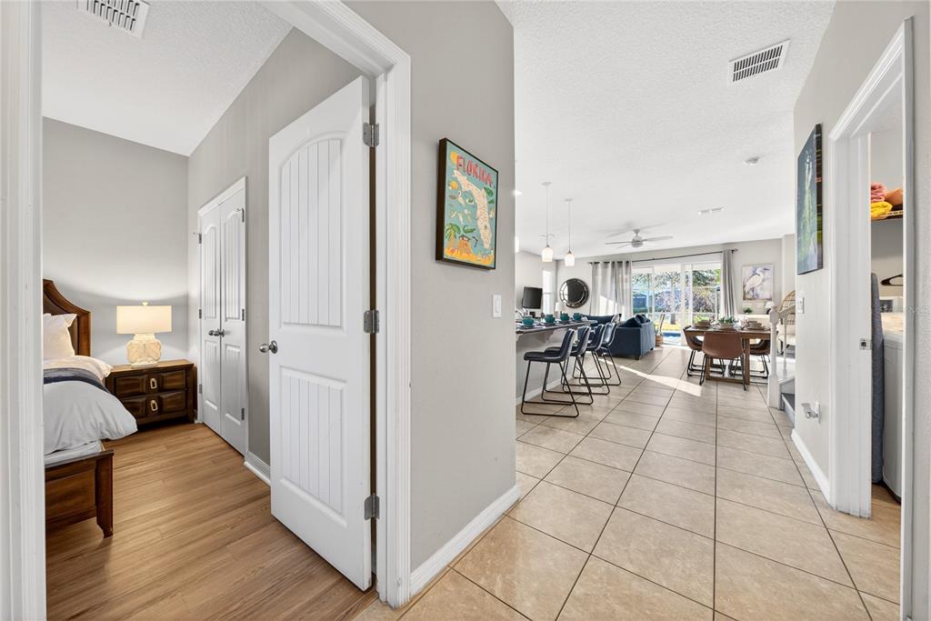 A view from a bedroom doorway looking into an open-concept living and dining area — 4787 TERRASONESTA DRIVE, DAVENPORT, FL