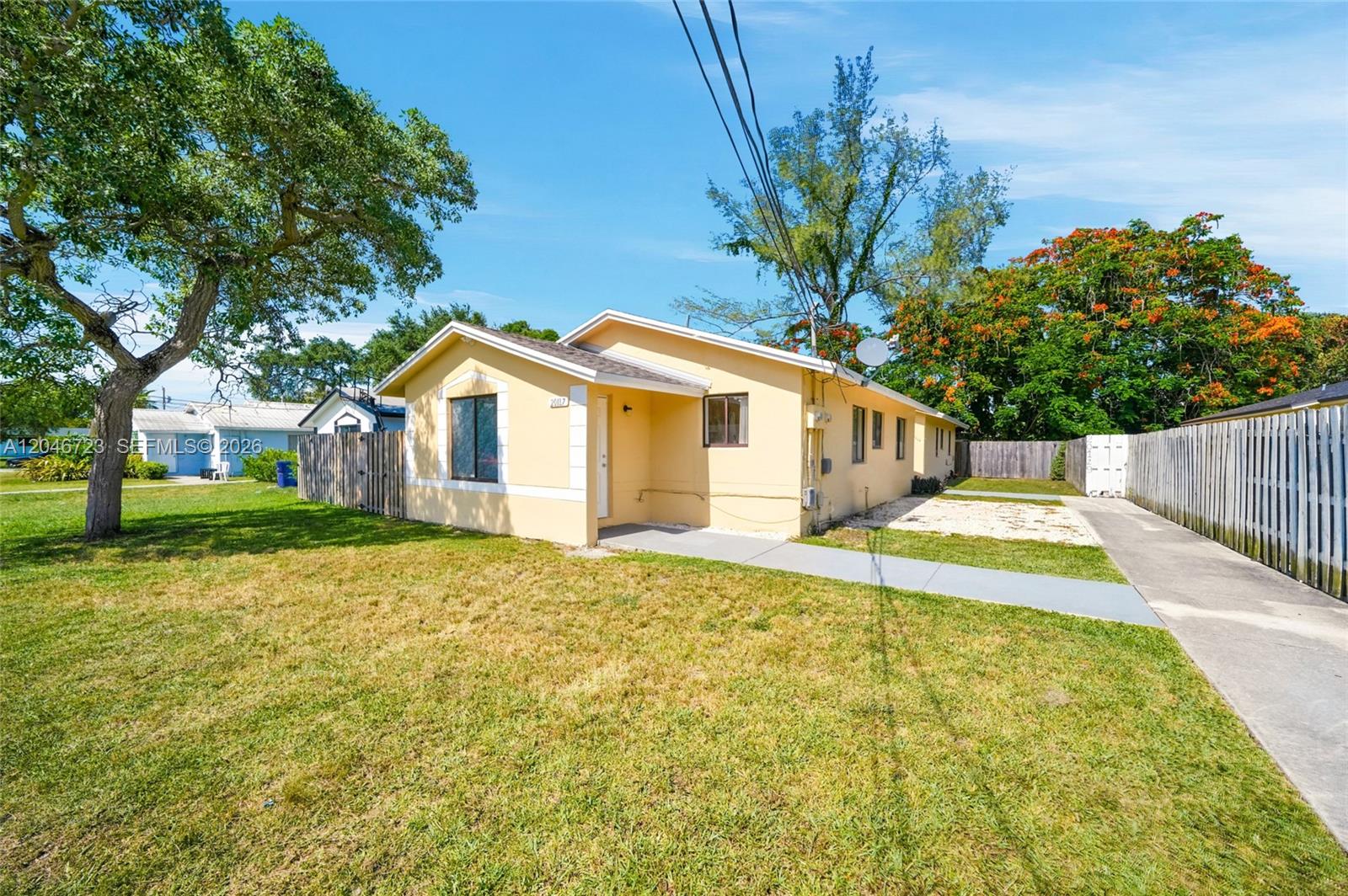 A single-story yellow house with a concrete walkway and a large tree in the yard — 20117 SW 88th Ct, Cutler Bay FL 33189, CUTLER BAY, FL