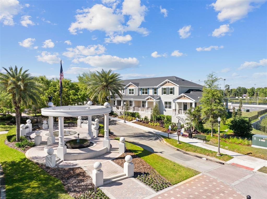An outdoor gazebo with a fountain sits in front of a multi-story residential building — 1406 BLUMBERG BOULEVARD, WINTER SPRINGS, FL