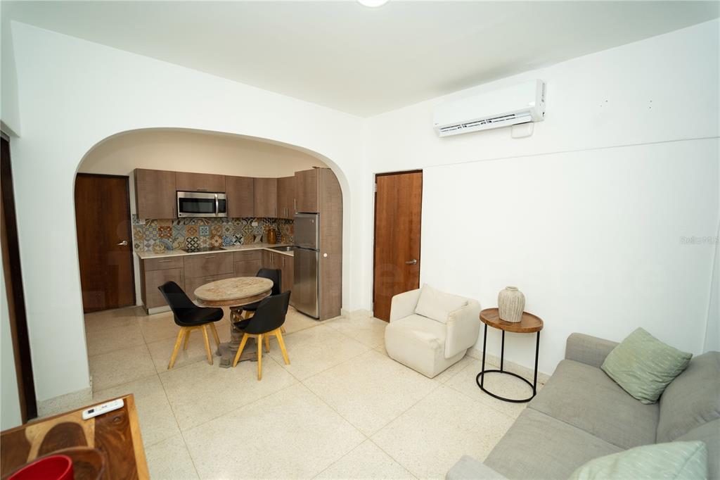 An open-concept living area features a kitchen with patterned tile backsplash and a dining table — 2019 CACIQUE STREET, SAN JUAN, PR