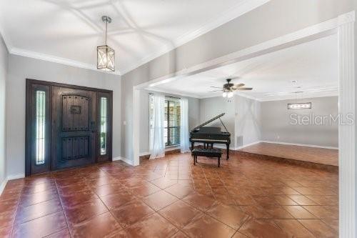 A foyer with tile floors leads into a living area featuring a grand piano — 306 N SWEETWATER COVE BOULEVARD, LONGWOOD, FL