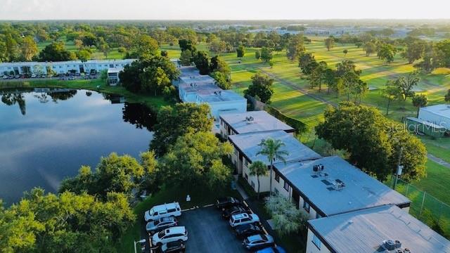 An aerial view shows apartment buildings situated next to a lake and a golf course — 625 N KEENE ROAD UNIT T5, CLEARWATER, FL