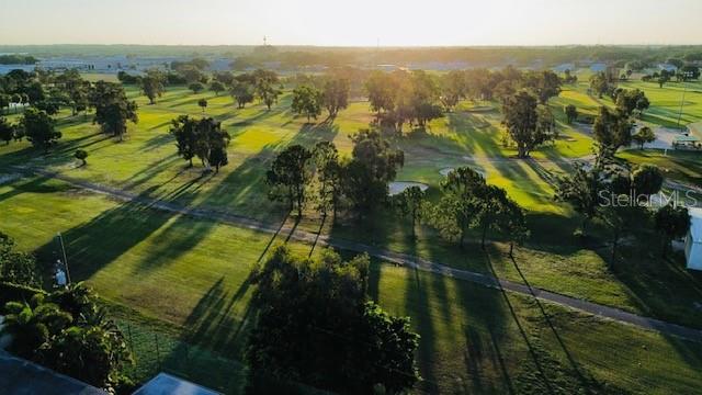 An aerial view of a golf course with scattered trees and long shadows at sunset — 625 N KEENE ROAD UNIT T5, CLEARWATER, FL