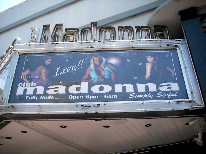 The exterior of Club Madonna features a large, illuminated sign with images of women — 1527 Washington Ave, Miami Beach FL 33139, MIAMI BEACH, FL