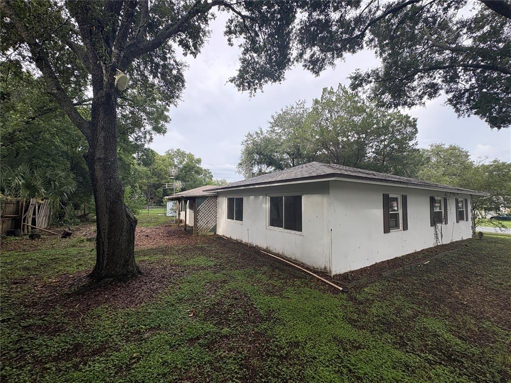 A white single-story house with a hip roof sits on a grassy lot with trees — 9202 N ABBOT DRIVE, CITRUS SPRINGS, FL