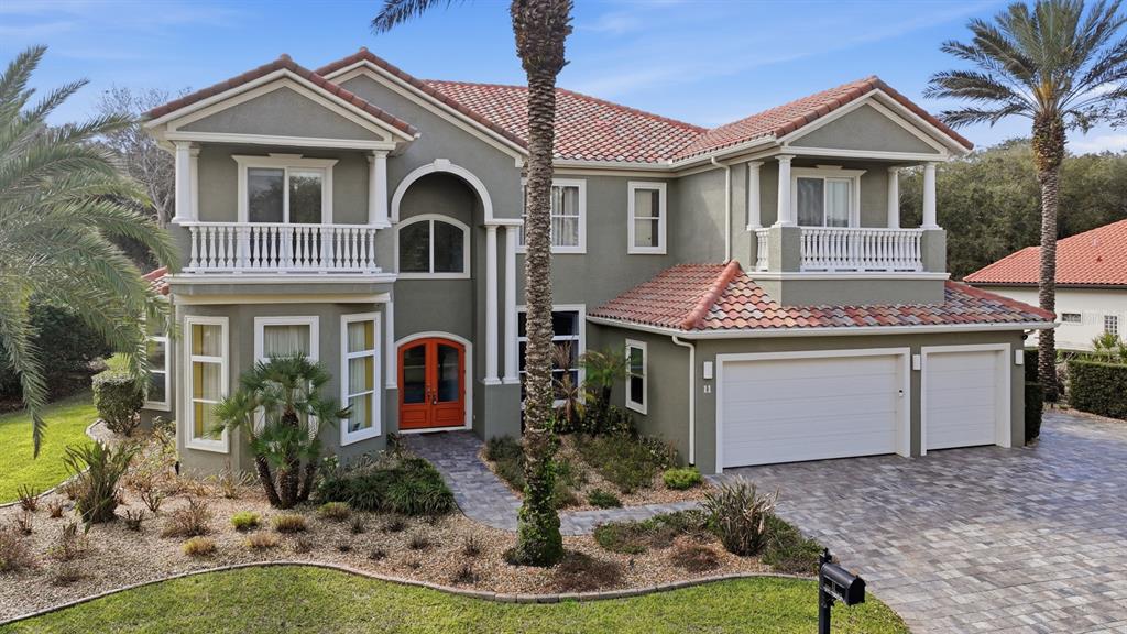 A two-story house with a garage and an inset photo of a screened-in pool — 11 OCEAN OAKS LANE, PALM COAST, FL