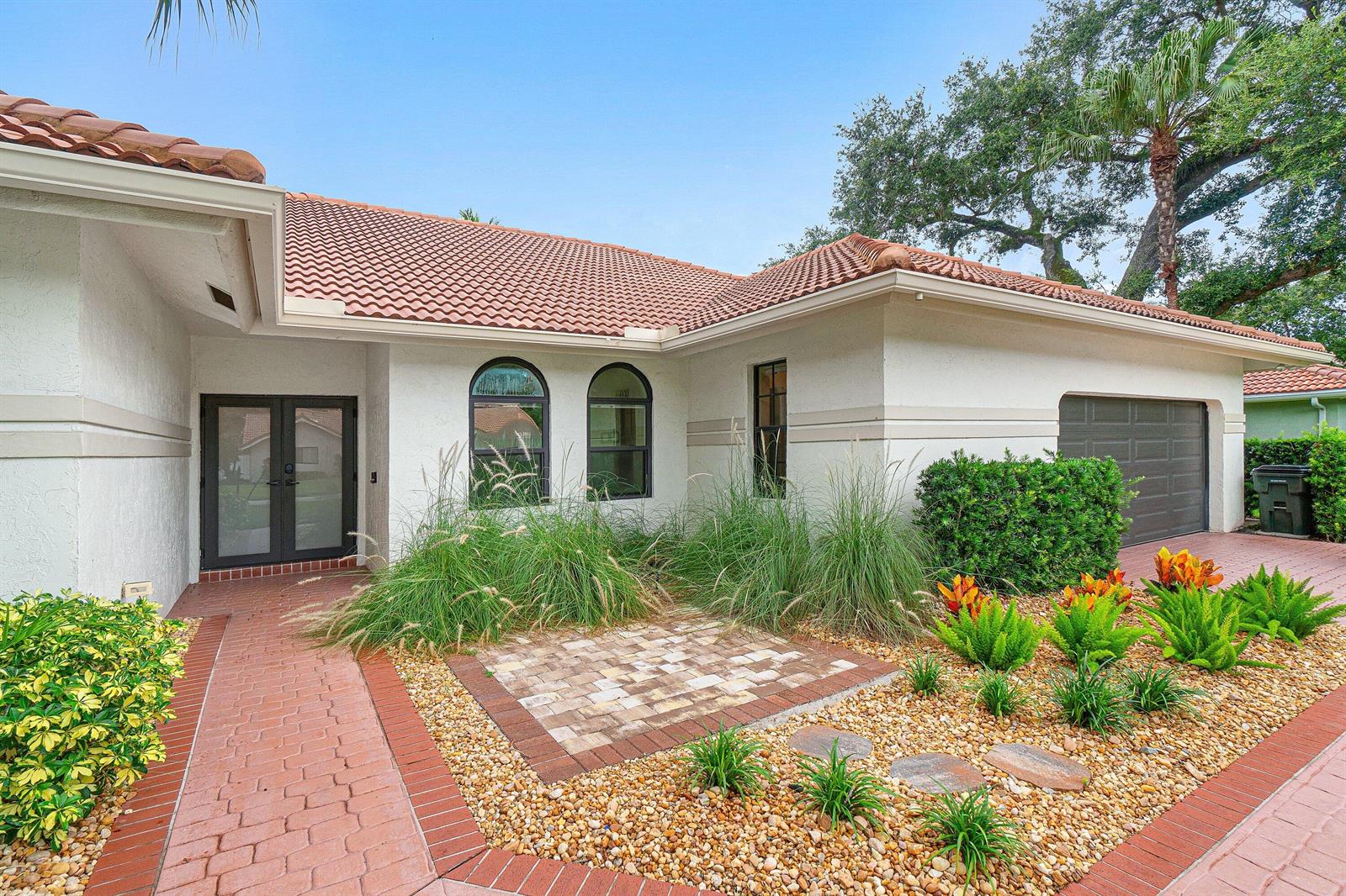 A single-story house with a tile roof and a yellow convertible parked in the driveway — 3615 SW 24th Lane, Delray Beach FL 33445, DELRAY BEACH, FL