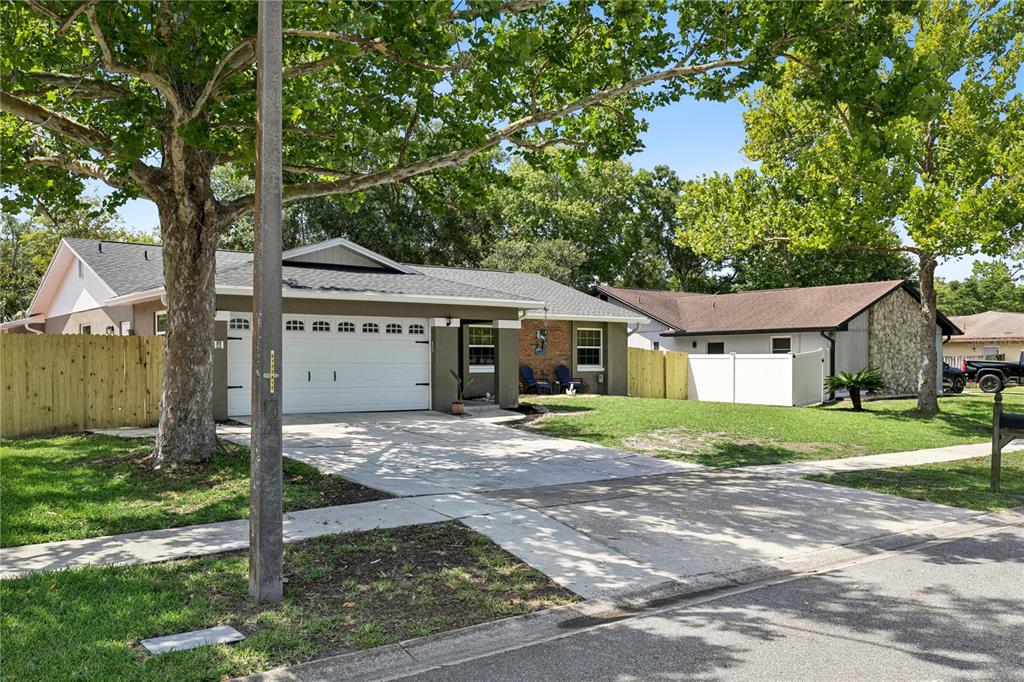 A sunroom features wood-paneled walls and ceilings, large windows, tile flooring, and a dining set — 809 BIG BUCK CIRCLE, WINTER SPRINGS, FL