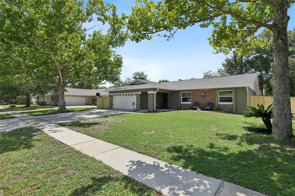A living room features wood-paneled vaulted ceilings, a built-in bar, and two arched doorways — 809 BIG BUCK CIRCLE, WINTER SPRINGS, FL