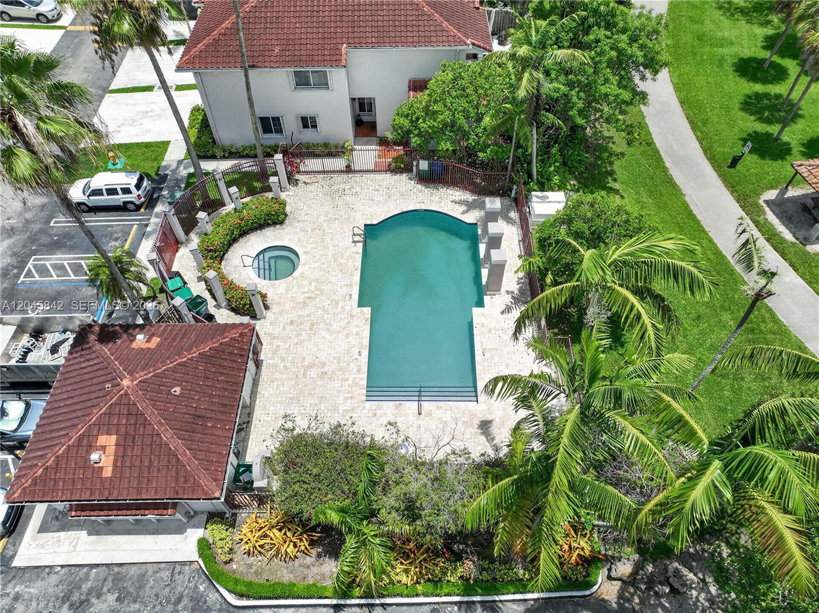 An aerial view shows a swimming pool, a hot tub, and a small building — 10210 SW 154th Pl # 111, Miami FL 33196, MIAMI, FL