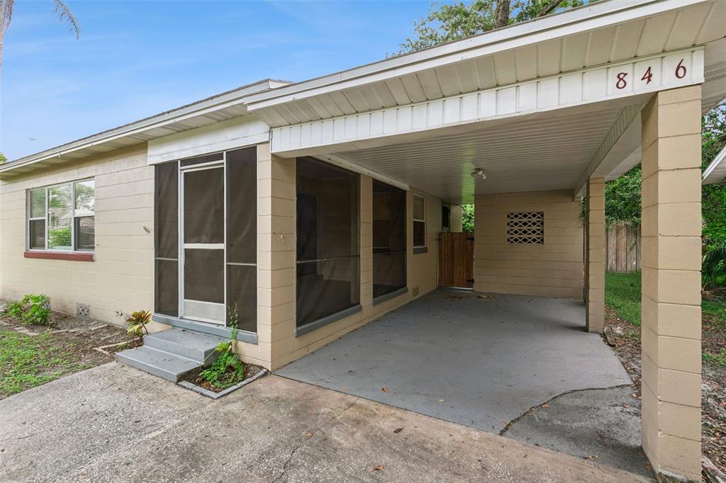 A beige concrete block house features a screened-in porch and an attached carport — 846 DRIVER AVENUE, WINTER PARK, FL