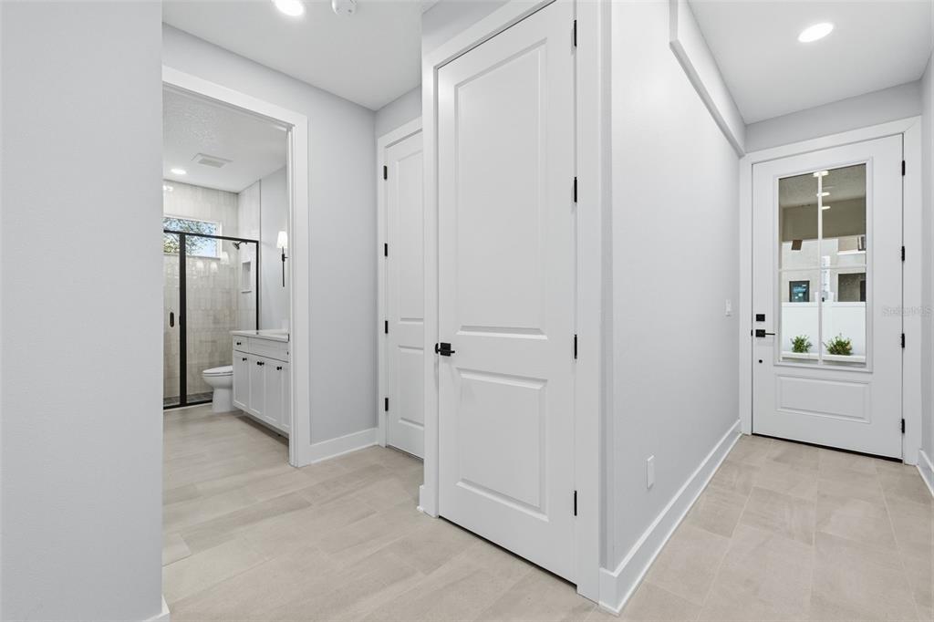 A bright entryway features light tile flooring, white walls, two interior doors, and a glass-paneled door — 4208 W CARMEN STREET UNIT D, TAMPA, FL
