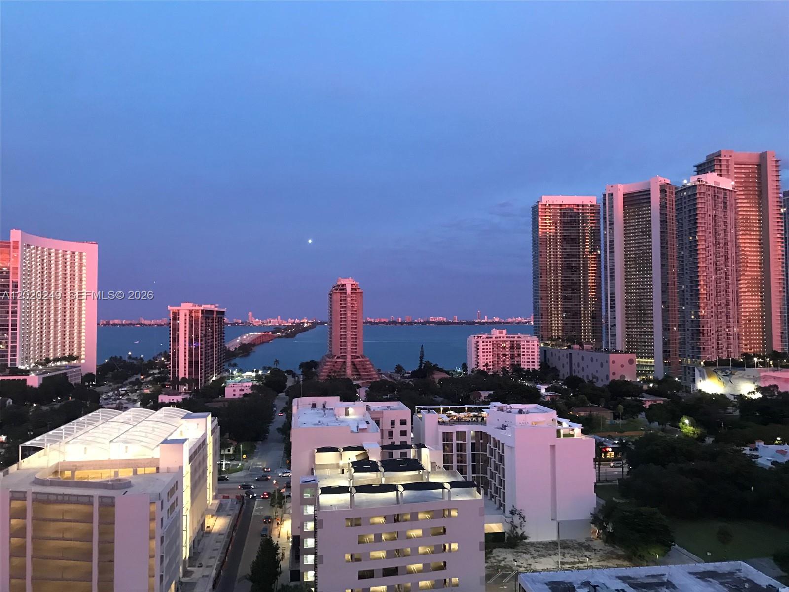 A kitchen features wood cabinets, stainless steel appliances, and black countertops on a tile floor — 3470 E Coast Ave # H1712, Miami FL 33137, MIAMI, FL