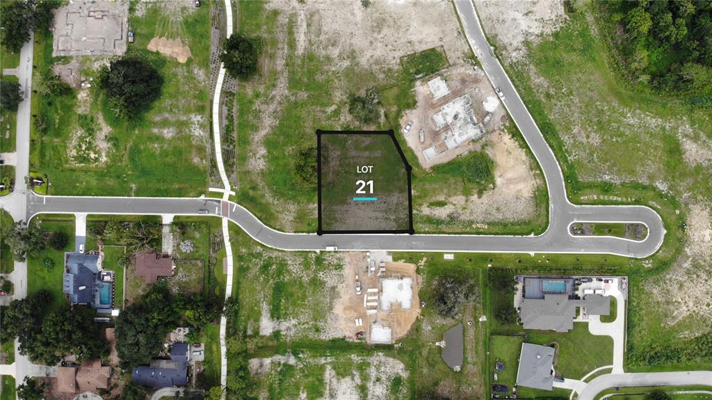 This aerial view shows a vacant residential lot marked as number 21 in a neighborhood — 523 WALKER STREET, OAKLAND, FL