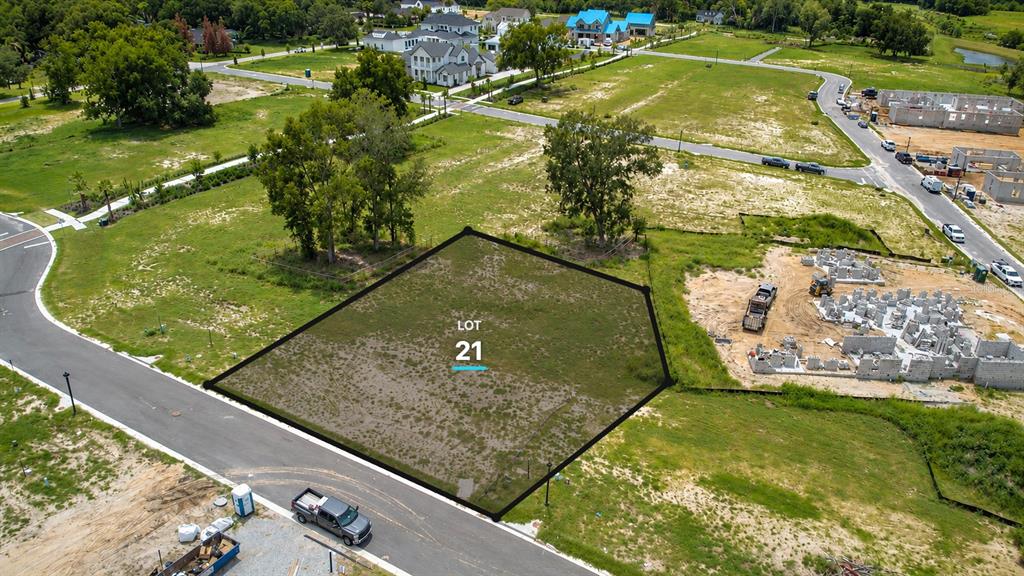 An aerial view shows a vacant, outlined residential lot labeled 21 in a developing neighborhood — 523 WALKER STREET, OAKLAND, FL