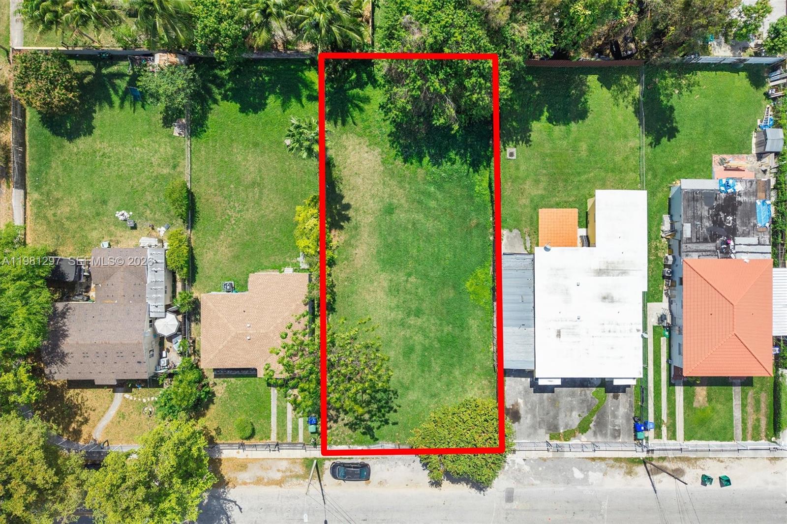 An aerial view shows a vacant rectangular lot situated between two existing residential houses — 1922 NW 33rd St, Miami FL 33142, MIAMI, FL