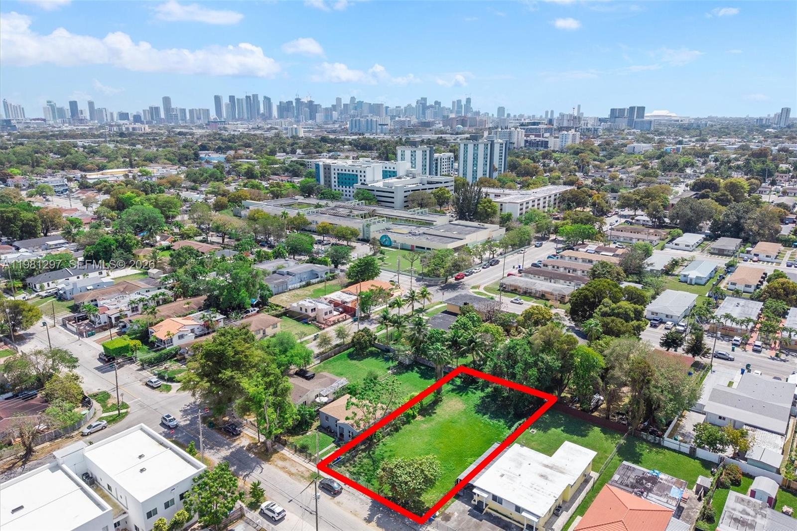 An aerial view shows a vacant rectangular lot outlined in red within a residential neighborhood — 1922 NW 33rd St, Miami FL 33142, MIAMI, FL