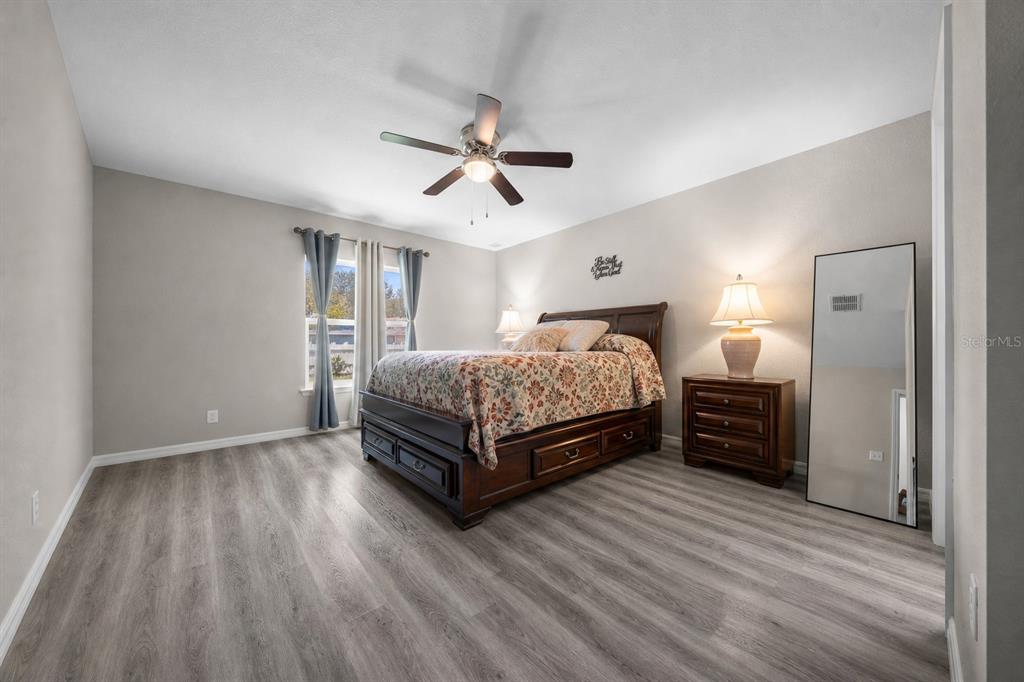 A hallway view showing two bedrooms on either side and a central bathroom with tile — 13358 SW 111TH STREET, DUNNELLON, FL