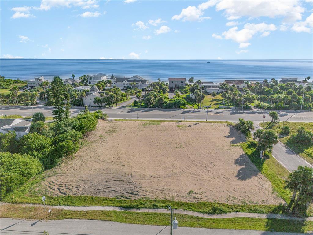 An elevated view of a vacant, sandy lot situated across the street from the ocean — 2752 S ATLANTIC AVENUE, DAYTONA BEACH, FL