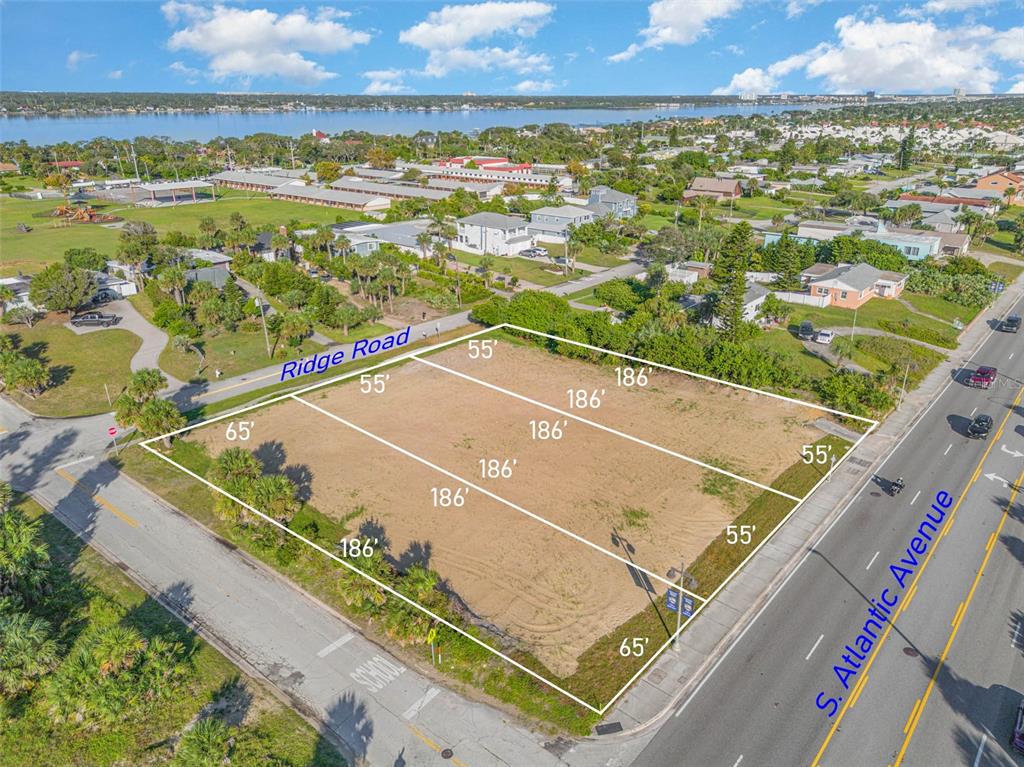 This aerial view shows a vacant, rectangular plot of land bordered by two paved roads — 2752 S ATLANTIC AVENUE, DAYTONA BEACH, FL