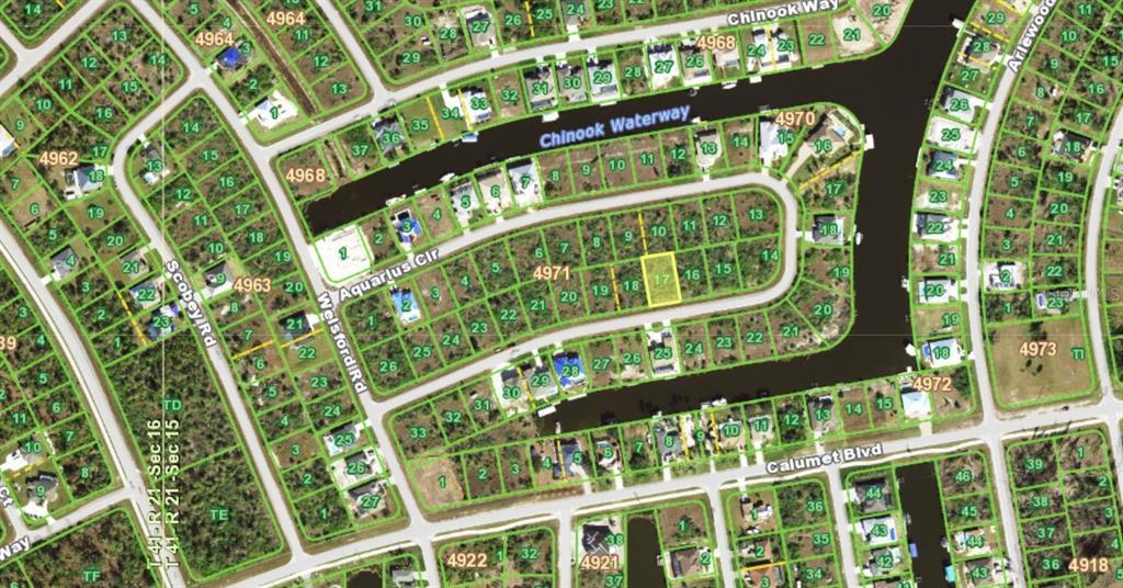 This is a satellite map view of a residential neighborhood with canal-front lots — 15205 AQUARIUS CIRCLE, PORT CHARLOTTE, FL