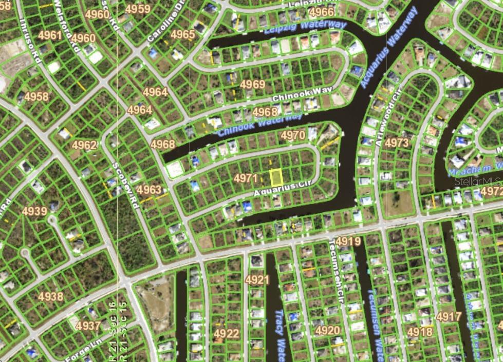 This is an aerial map showing a vacant residential lot highlighted in yellow — 15205 AQUARIUS CIRCLE, PORT CHARLOTTE, FL