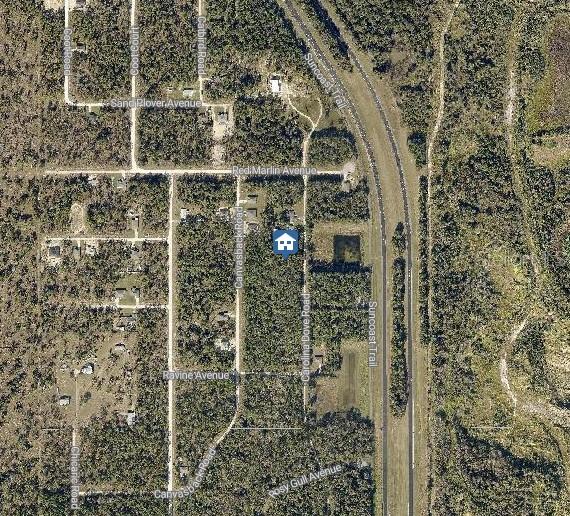 This is an aerial map view showing a residential property location surrounded by wooded areas — LOT 1021 CAROLINA DOVE ROAD, WEEKI WACHEE, FL