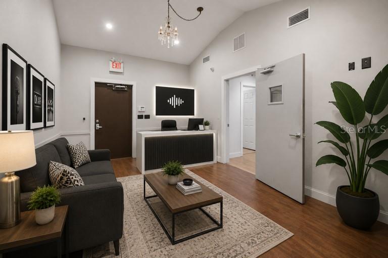 A modern office reception area features a dark desk, gray sofa, and a large plant — 2250 N VOLUSIA AVENUE, ORANGE CITY, FL