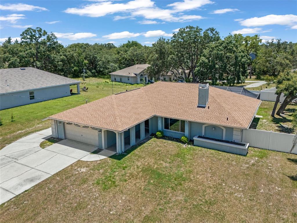 An aerial view of a single-story house with a tan roof and a two-car garage — 7376 SKYLARK DRIVE, SPRING HILL, FL