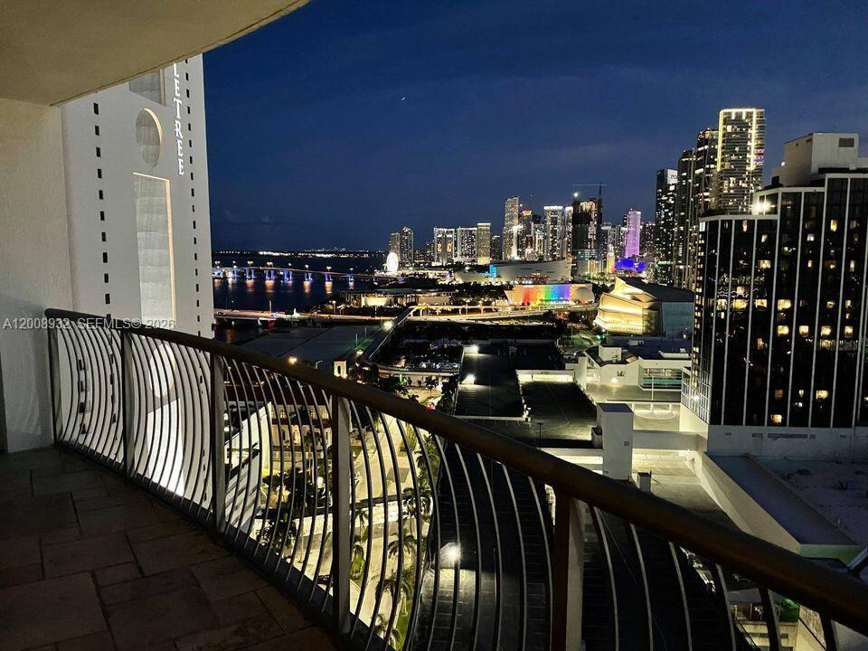 A balcony view overlooking a city skyline and a bridge at night — 1750 N Bayshore Dr # 2514, Miami FL 33132, MIAMI, FL