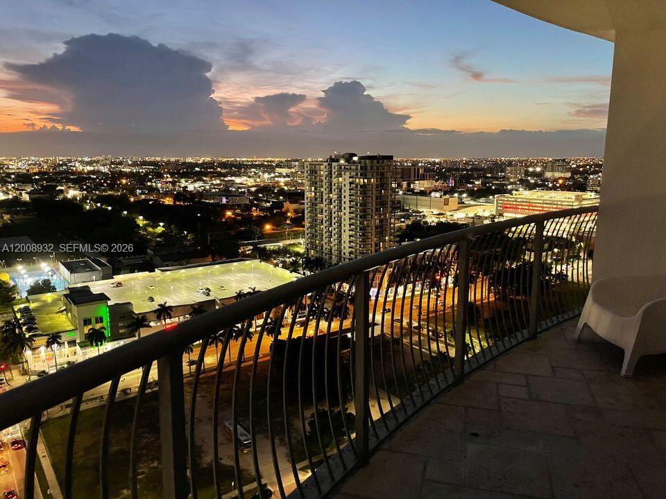 A balcony view overlooking a city skyline at sunset with a parking structure below — 1750 N Bayshore Dr # 2514, Miami FL 33132, MIAMI, FL