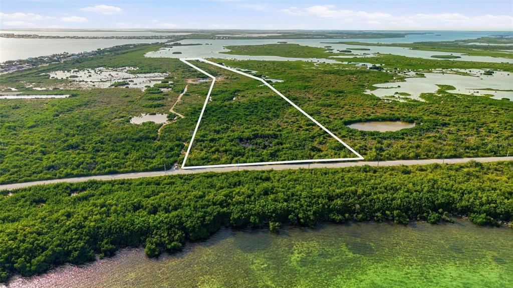 An aerial view shows a triangular plot of land outlined in white near the water — NILES ROAD, SUMMERLAND KEY, FL
