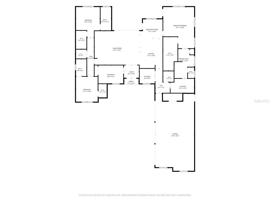An open-concept living room and kitchen featuring wood-look tile floors and exposed ceiling beams — 4050 PALMA CEIA CIRCLE, WINTER HAVEN, FL