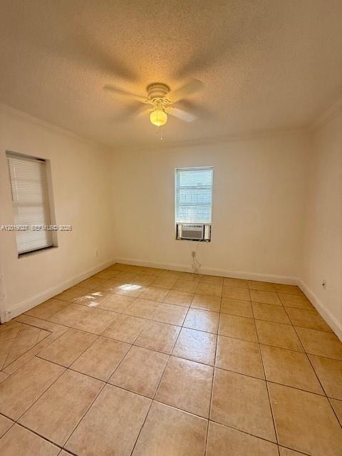 An empty room features beige tile flooring, white walls, a ceiling fan, and a window — 3698 William Ave # 5, Miami FL 33133, MIAMI, FL