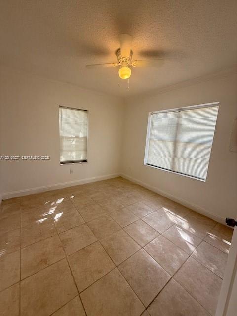 An empty bedroom features light-colored tile flooring, white walls, two windows with blinds, and a ceiling fan — 3698 William Ave # 5, Miami FL 33133, MIAMI, FL