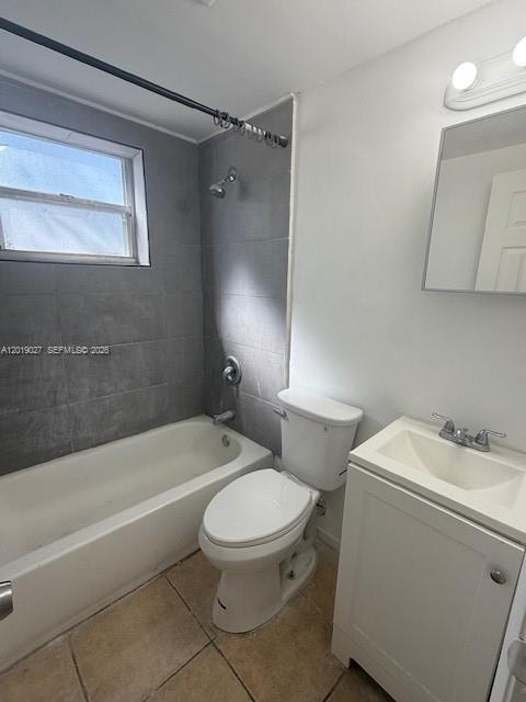 A bathroom features a white vanity, a toilet, and a bathtub with gray tile walls — 3698 William Ave # 5, Miami FL 33133, MIAMI, FL