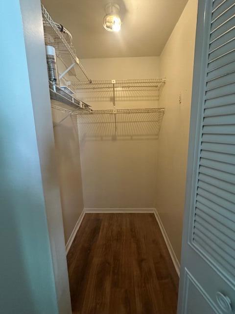 A small walk-in closet features wire shelving, light-colored walls, and wood-look flooring — 3625 La Aires Court # B2, FL 33463, FL