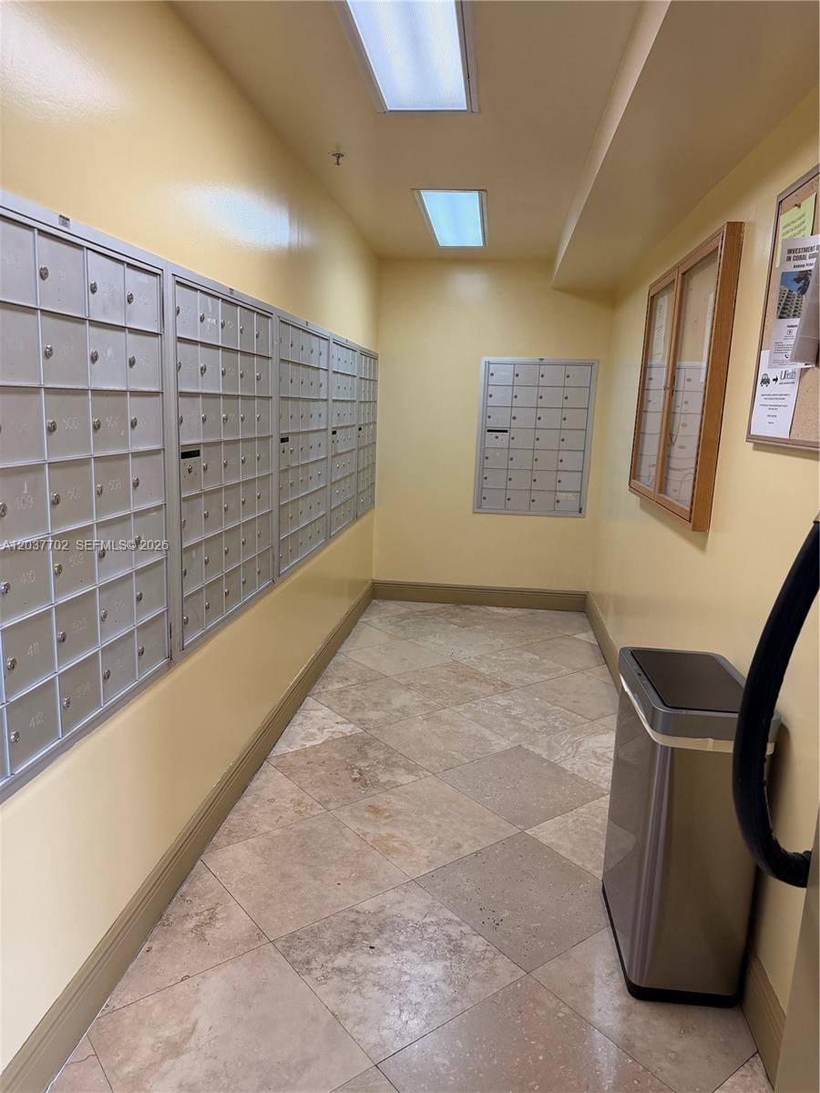 Two gold luggage carts stand on a tiled floor near a window and a plant — 3500 Coral Way # 907, Miami FL 33145, MIAMI, FL