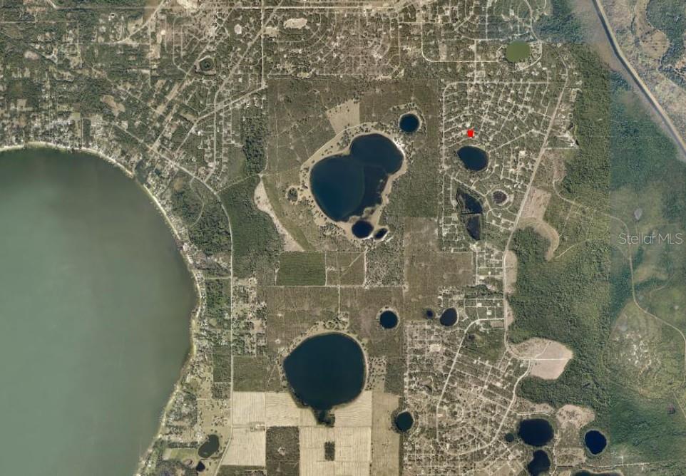 This is an aerial map showing residential lots, wooded areas, and several small lakes — FISHER WAY COURSE, OCKLAWAHA, FL